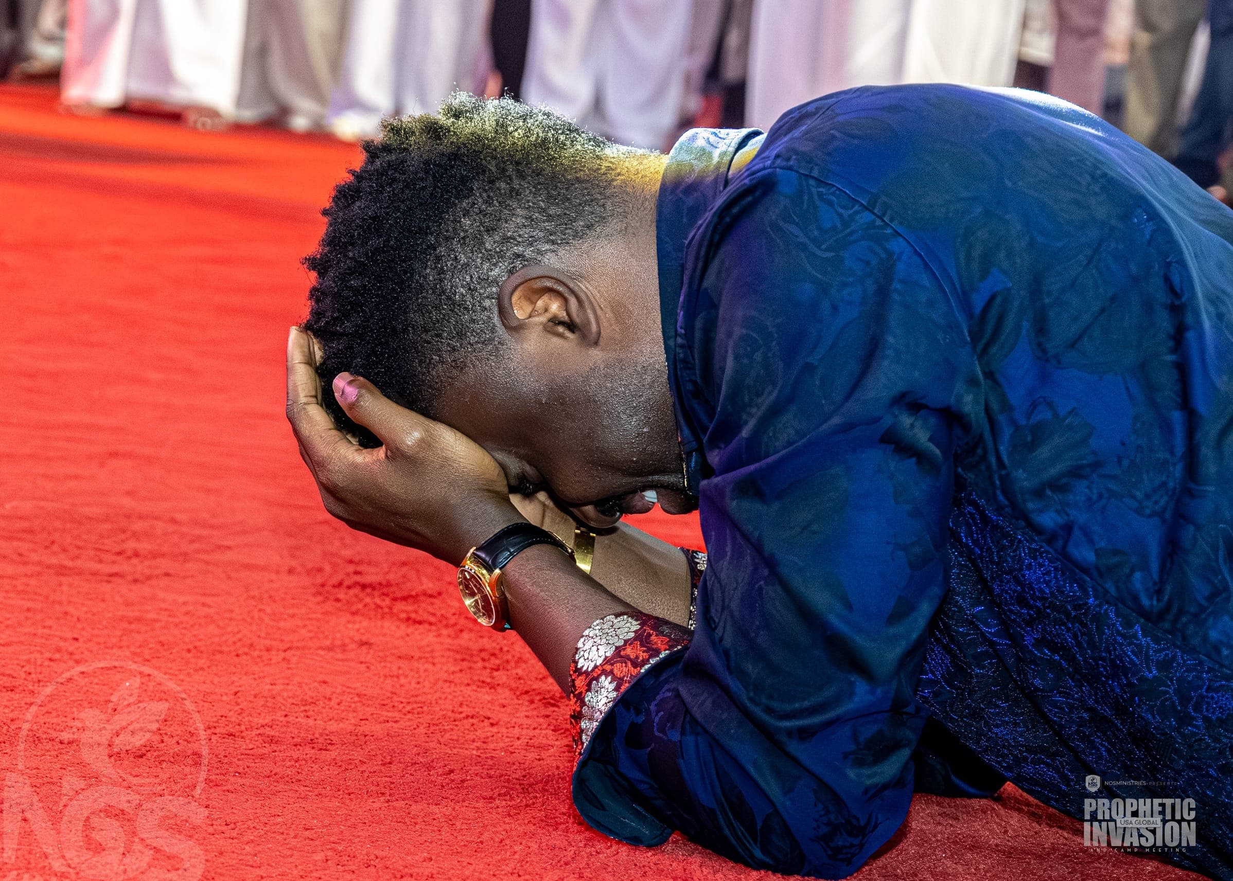 A woman lying prostrate in prayer